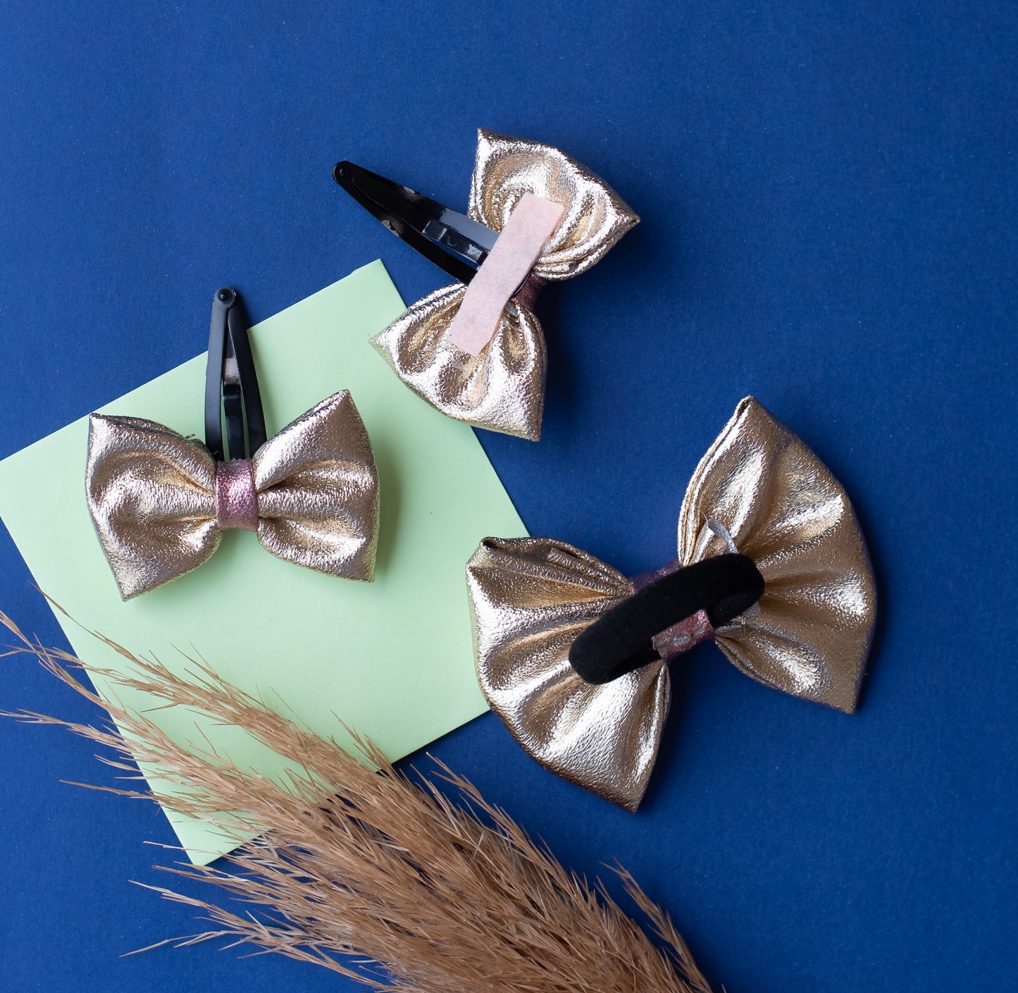 Combo: Fancy gold shiny bow on tic-tac pins and one matching rubberband (3 nos) - Gold