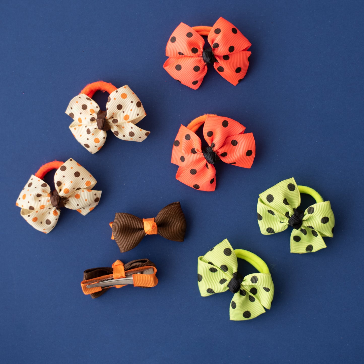 Combo:  One pair of aligator clips and 3 pairs of polka dotted rubberbands - Brown, Off White, Orange, Fluoroscent Green