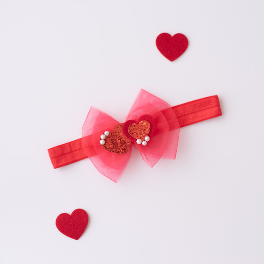 Beautiful red net bow with glitter hearts embellished with pearls on super soft stretchy band. - Red