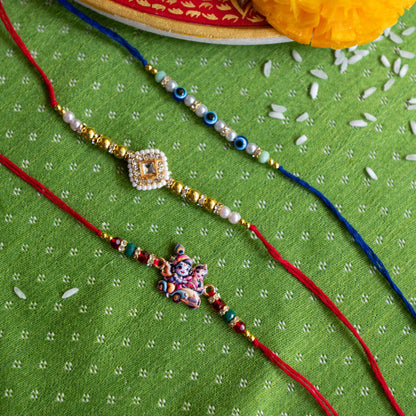 Ribbon Candy Set of 3 Rakhis-Radha Krishna, Kundan Charm and Evil Eye Beads - Multicolor
