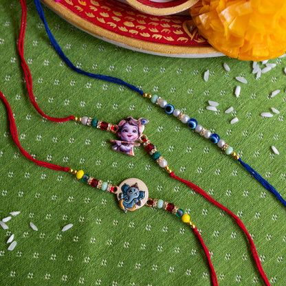 Ribbon Candy Set of 3 Rakhis-Ganesha, Krishna Charms & Evil Eye Beads - Multicolor