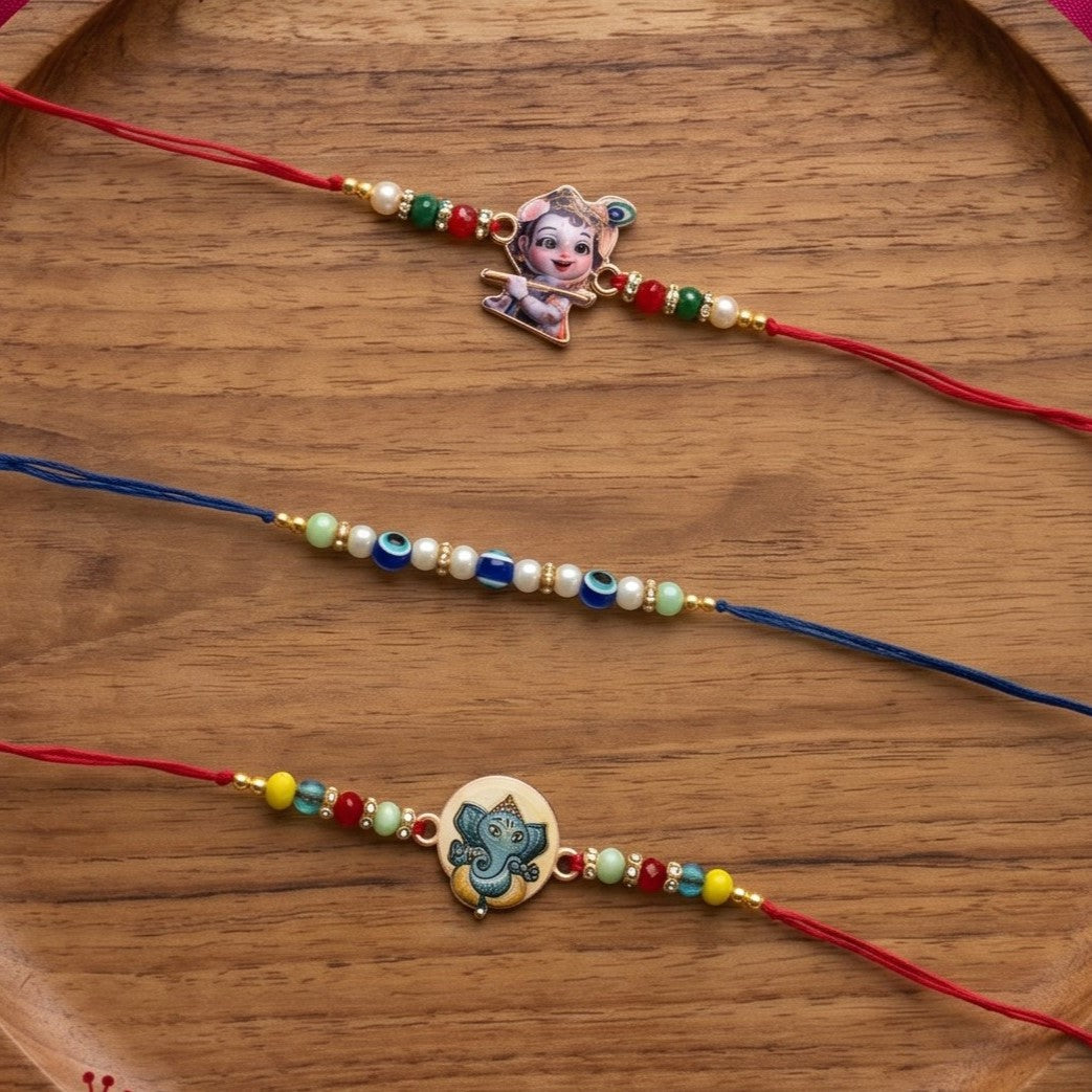 Ribbon Candy Set of 3 Rakhis-Ganesha, Krishna Charms & Evil Eye Beads - Multicolor