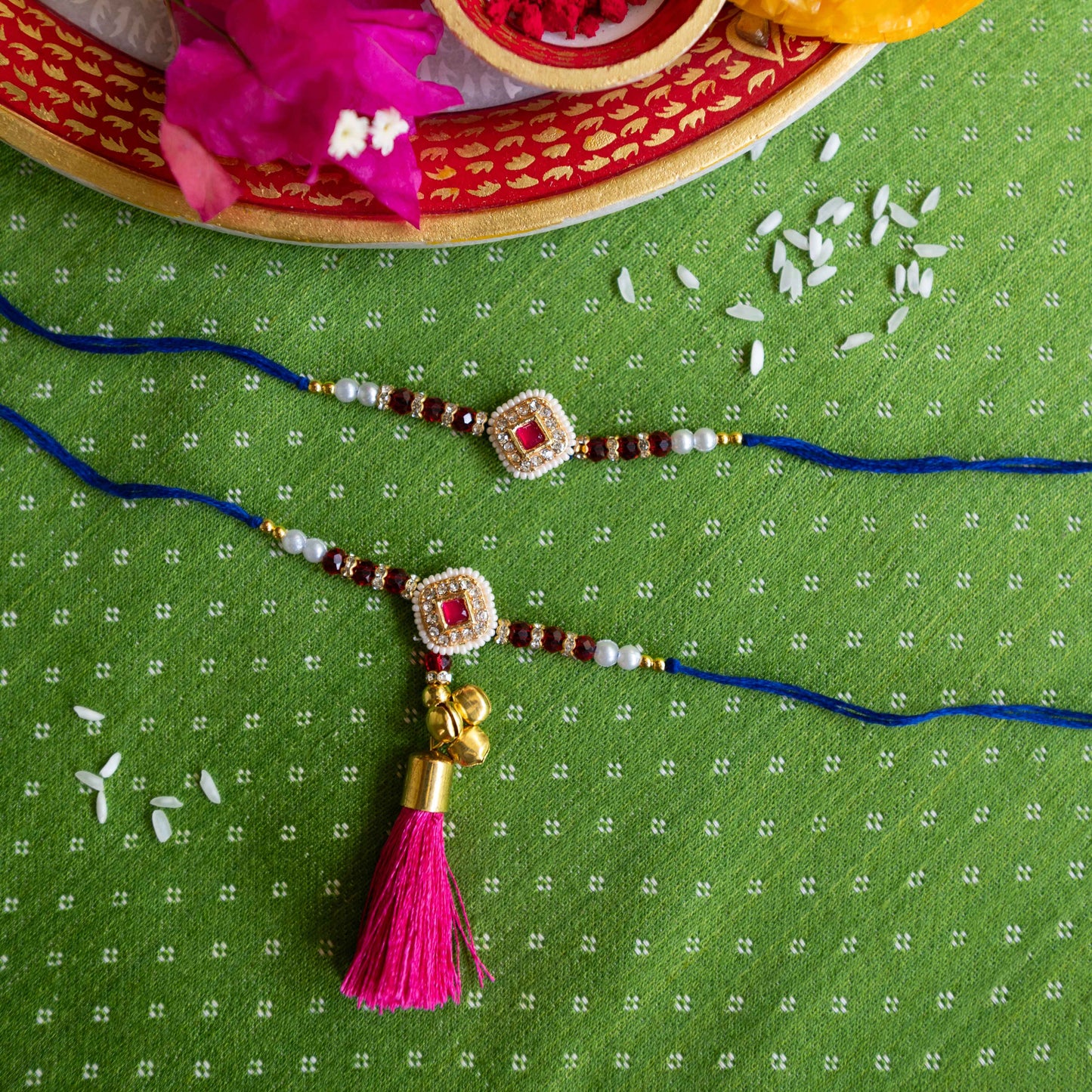 Ribbon Candy Set of 2 Rakhis-Bhai Bhabhi's kundan Charm B  - Pink, Blue