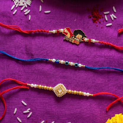 Ribbon Candy Set of 3 Rakhi-Kundann, Evil Eye, and 'Super Bro' Charm – Gold & Red
