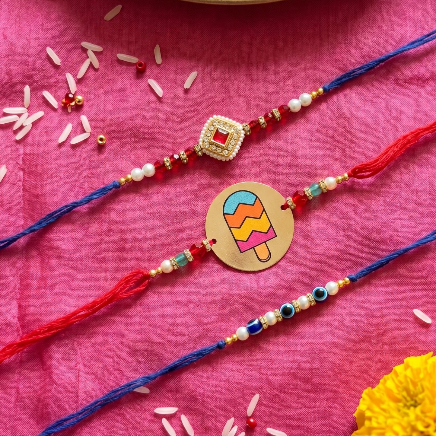Ribbon Candy Set of 3 Rakhi-Metal, Kundan Charm & Evil Eye Beads– Red & Blue