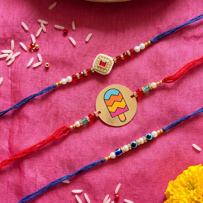 Ribbon Candy Set of 3 Rakhi-Metal, Kundan Charm & Evil Eye Beads– Red & Blue