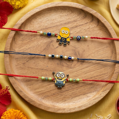 Ribbon Candy Set of 3 Rakhis-Cartoon Charms & Evil Eye Beads– Red & Blue