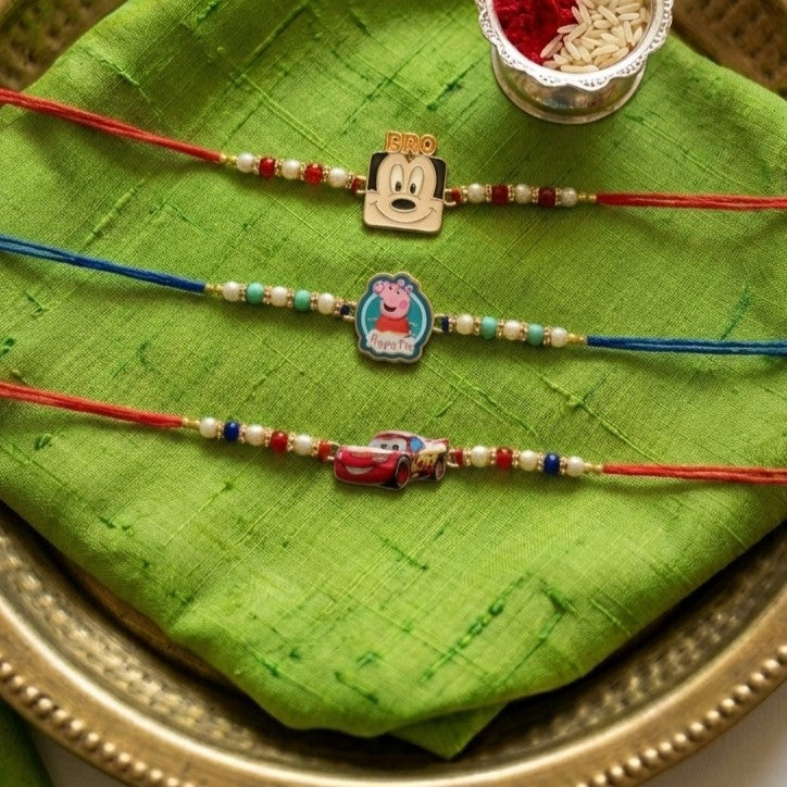 Ribbon Candy set of 3 Rakhi-Cartoons & a Car Charms- Blue, Red