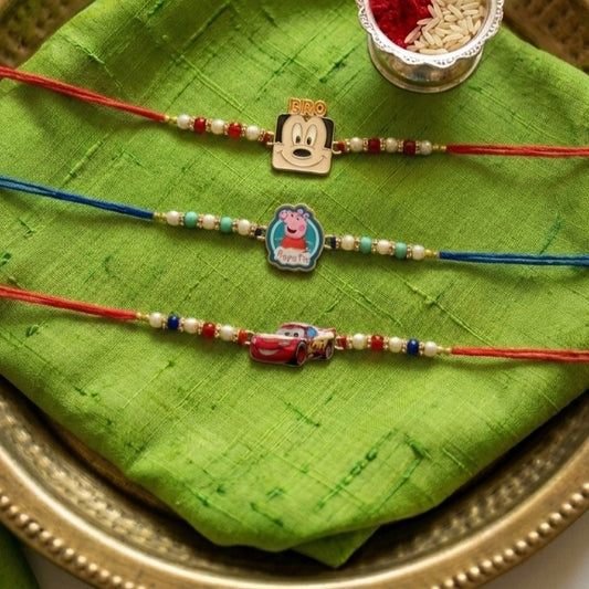 Ribbon Candy set of 3 Rakhi-Cartoons & a Car Charms- Blue, Red