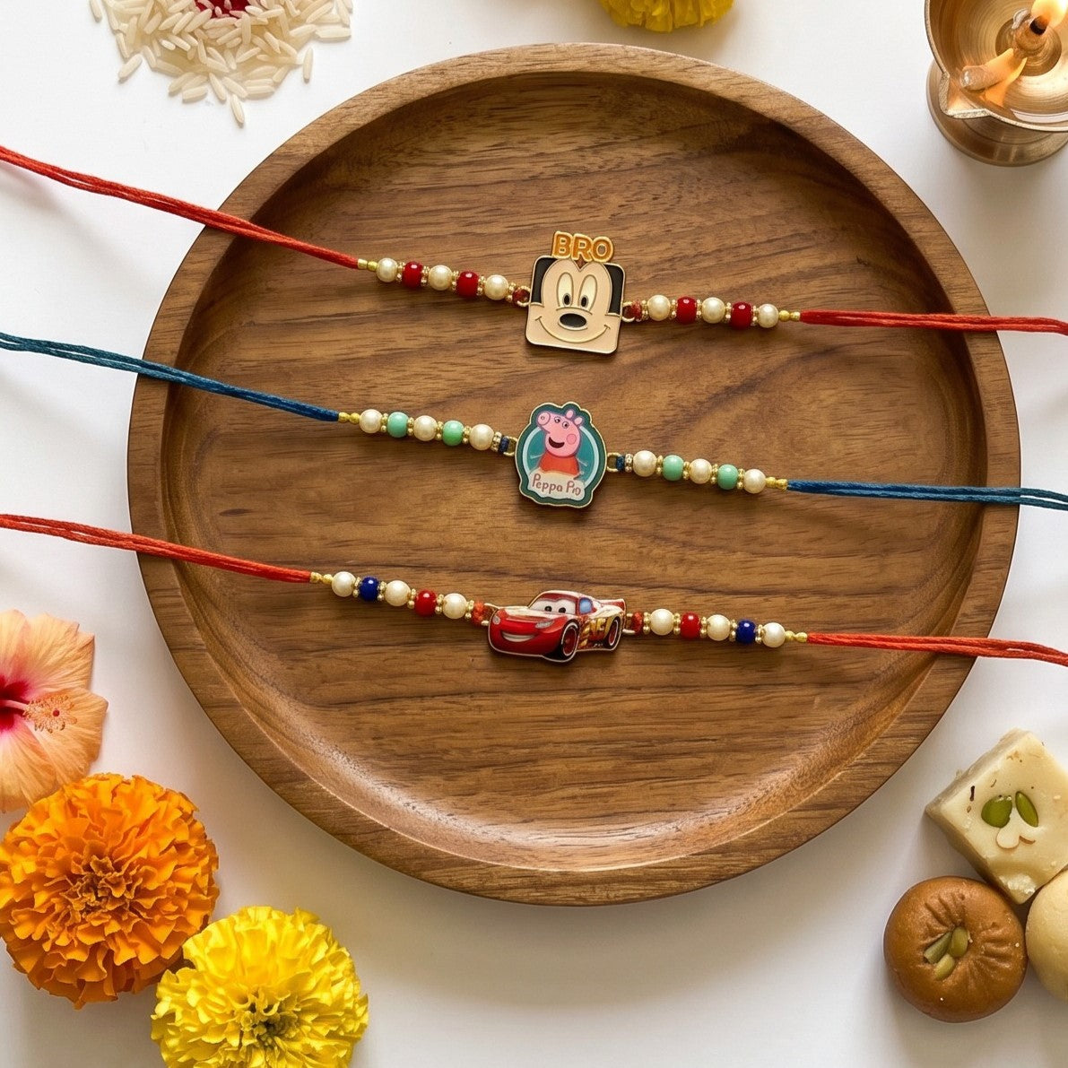 Ribbon Candy set of 3 Rakhi-Cartoons & a Car Charms- Blue, Red