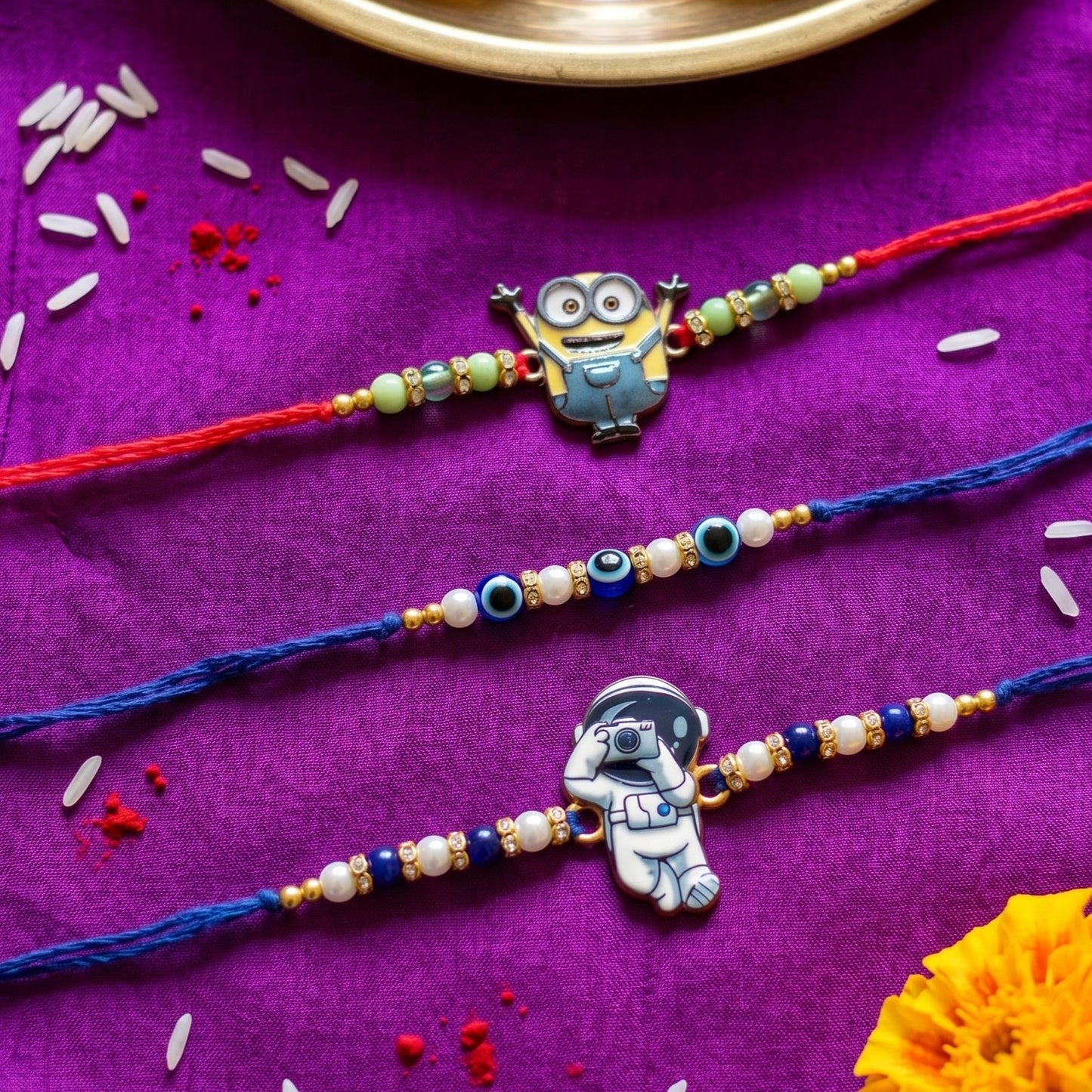 Ribbon Candy set of 3 Rakhi-Cartoon, Astronaut Charms and Evil Eye Beads- Blue, Red