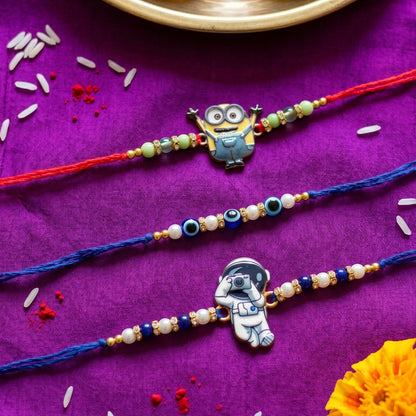 Ribbon Candy set of 3 Rakhi-Cartoon, Astronaut Charms and Evil Eye Beads- Blue, Red
