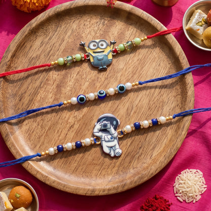 Ribbon Candy set of 3 Rakhi-Cartoon, Astronaut Charms and Evil Eye Beads- Blue, Red