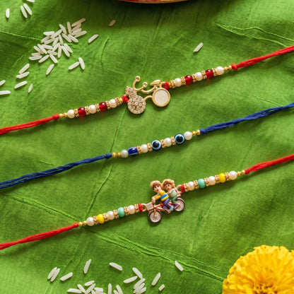 Ribbon Candy set of 3 Rakhi-Cartoon Charms and Evil Eye Beads- Blue, Red